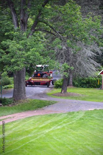 Farm Tractor Pulling Hay Disc On Country Road