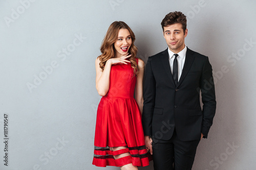 Portrait of a happy cheerful couple dressed in formal wear photo