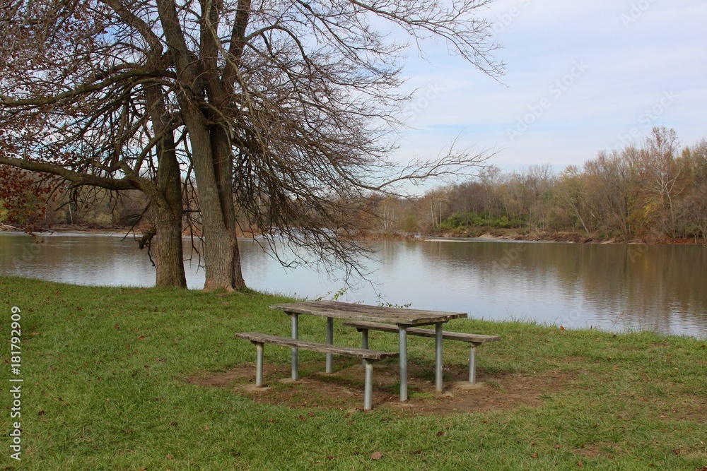 The empty picnic table by the river in the park. The empty picnic table by the river in the park.