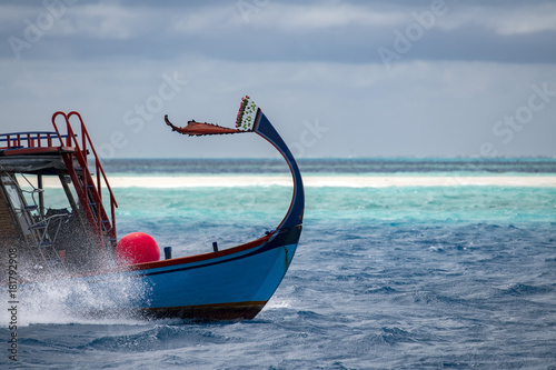 maldivian dhoni boat in blue ocean
