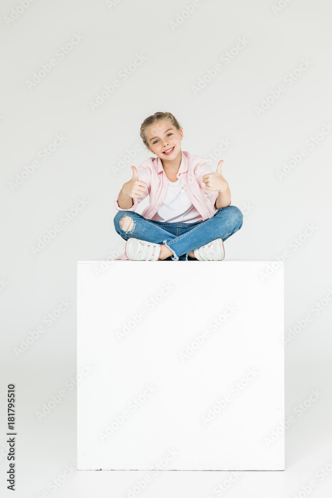 child showing thumbs up child showing thumbs up