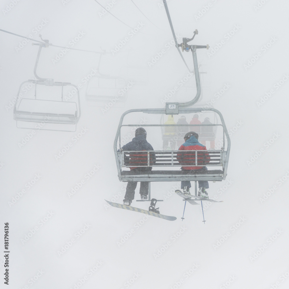 Tourists on ski lifts in foggy weather, Whistler, British Columbia, Canada Tourists on ski lifts in foggy weather, Whistler, British Columbia, Canada
