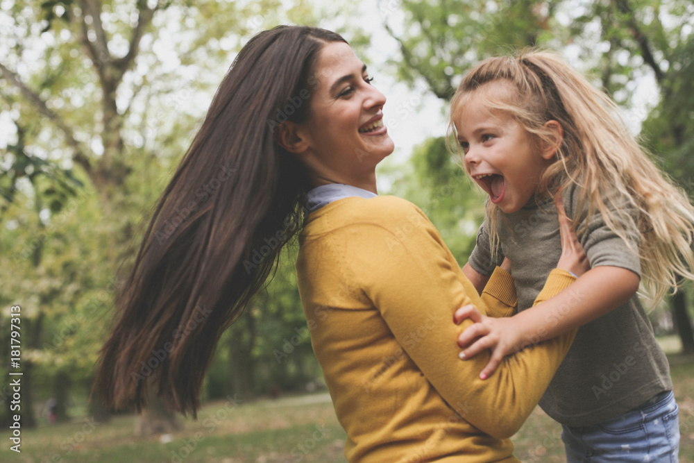 Fototapeta premium Mother carrying daughter have play.