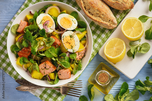 Healthy salad with salmon, potatoes, eggs and lamb's lettuce.