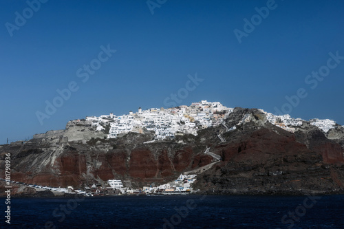 View of famous white buildings of Oia town on cliff in Santorini, Greece