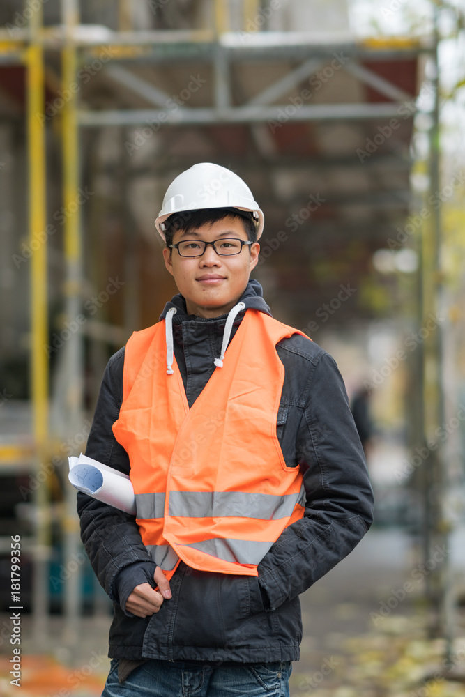 Young Asian engineer at work on construction site Young Asian engineer at work on construction site