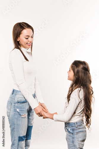 Mother and daughter holding hands