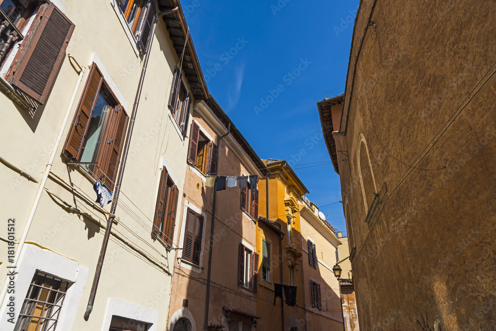 Blue sky over a narrow alley in Rome