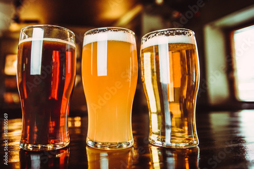 Glasses of light and dark beer on a pub background