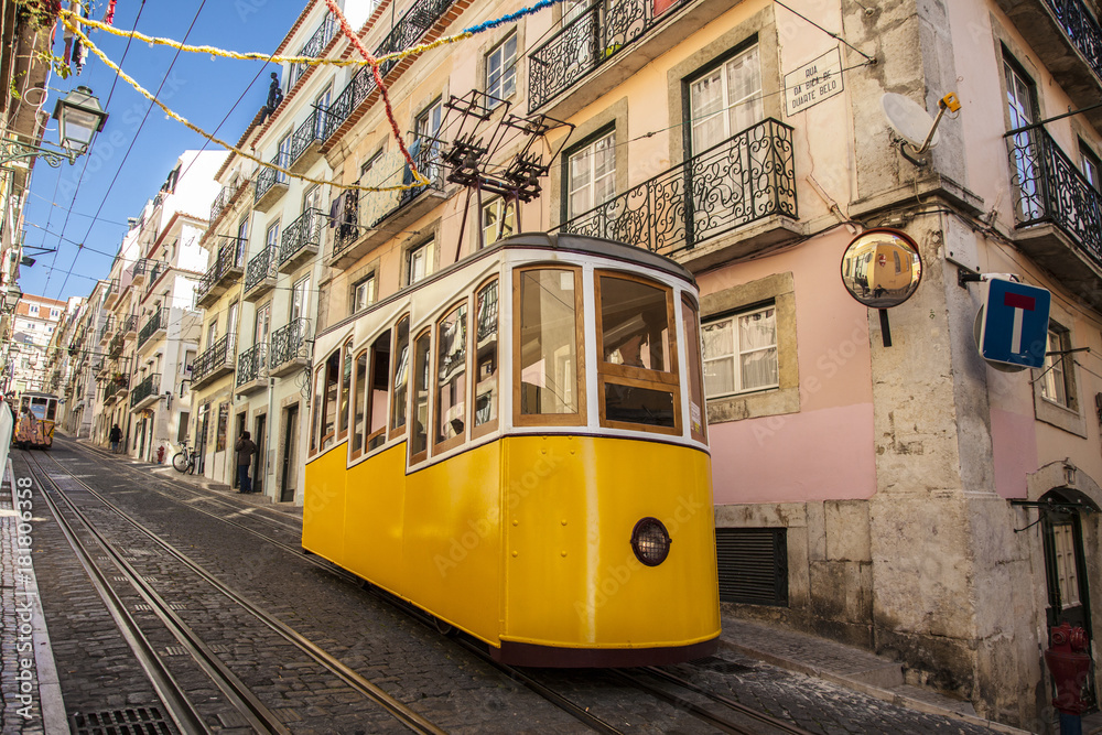 Colorful life in Portugal. Yellow tram on the city streets.