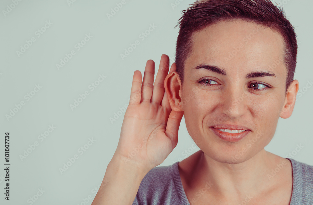 Closeup head shot macro face young nosy woman hand to ear gesture carefully intently secretly listening juicy gossip conversation news isolated green gray wall background Human face expression emotion Closeup head shot macro face young nosy woman hand to ear gesture carefully intently secretly listening juicy gossip conversation news isolated green gray wall background Human face expression emotion