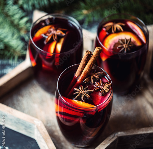 Christmas hot mulled wine in a glass with spices and citrus fruit. Mulled wine with cinnamon, anise and orange. 