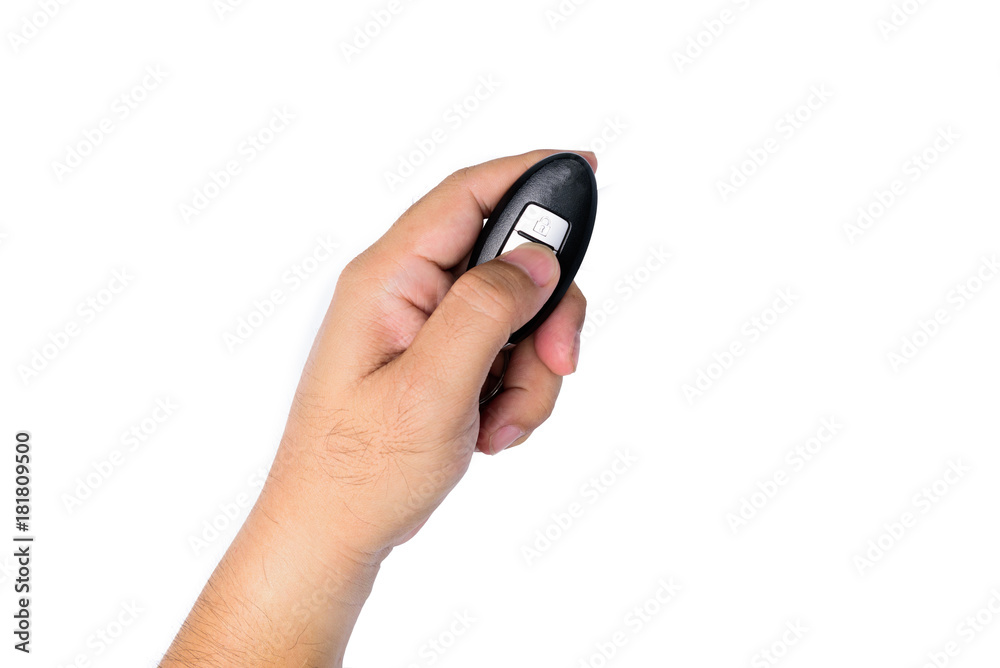 A man's hand Pressing car remote button to open or close the car door lock on white background or isolated A man's hand Pressing car remote button to open or close the car door lock on white background or isolated