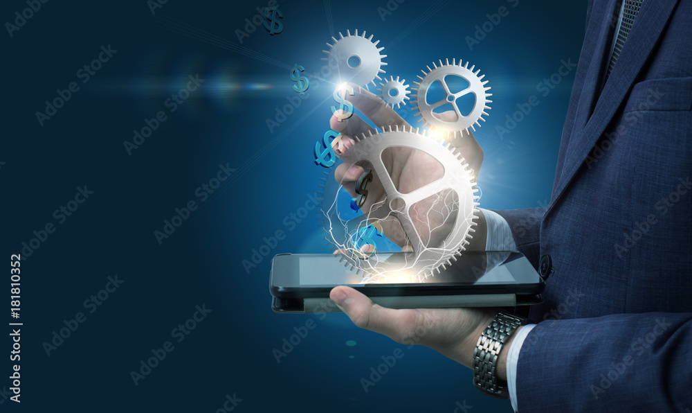 Αυτοκόλλητο Businessman on the tablet works with the mechanism of earning dollars