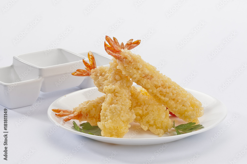 Tempura Jumbo Shrimps with salad and salsa dip on white plate and white background Tempura Jumbo Shrimps with salad and salsa dip on white plate and white background