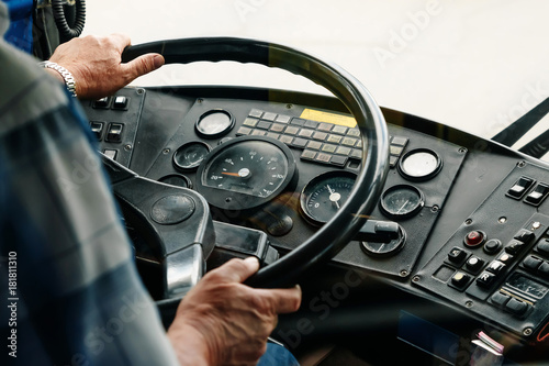 Driver man behind the wheel view from the back, close-up hands