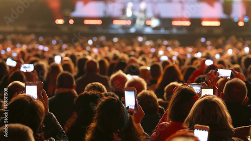 many people with smart phones at live concert