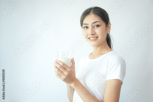 Young Asian Woman holding milk with smile on white background.