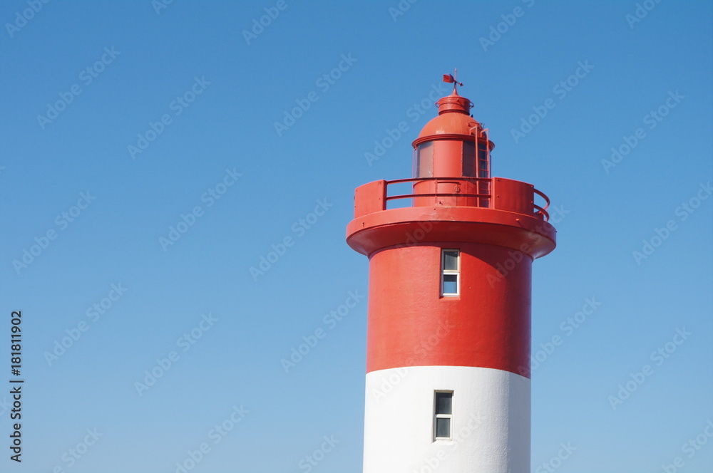Lighthouse at Unhlanga Rocks in Durban South Africa painted a distinct red and white and managed by the Oyster Box Hotel since 1954