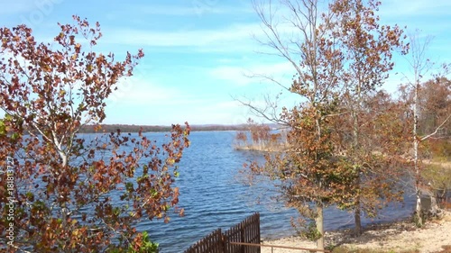 View of beautiful landscape with golden trees and lake in the fall. photo