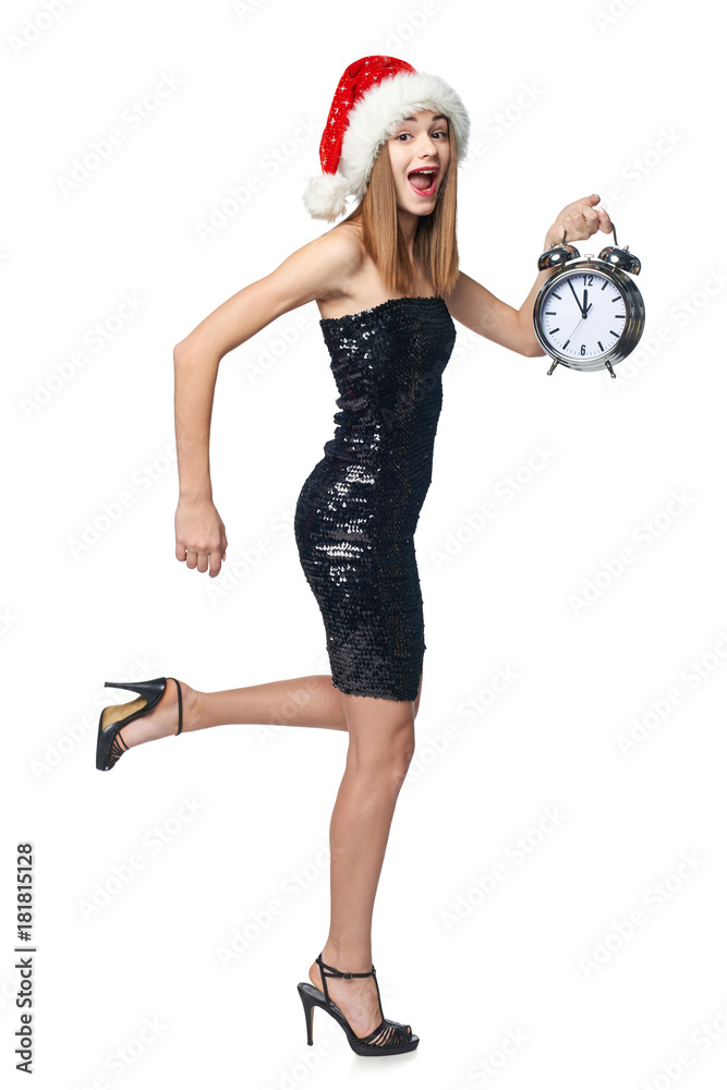 Full length happy Christmas girl in sequined dress and Santa hat running with alarm clock counting to midnight Full length happy Christmas girl in sequined dress and Santa hat running with alarm clock counting to midnight