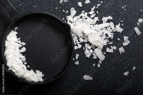 Fresh coconut flakes or white chocolate chip isolated on dark background with copy space 