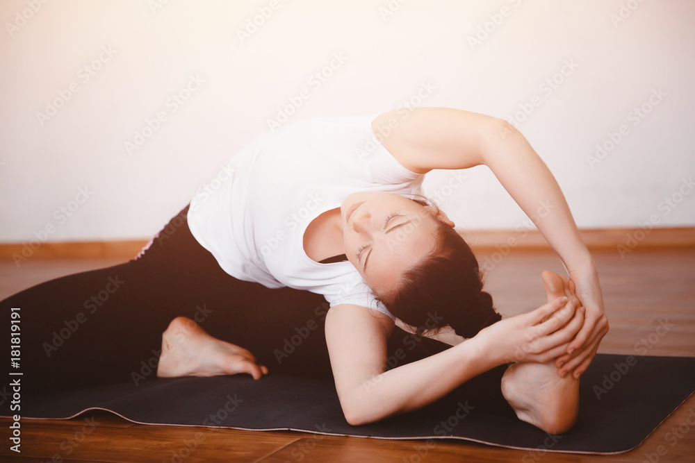 Yoga Concept. Close up woman meditates while practicing yoga in training hall or home.