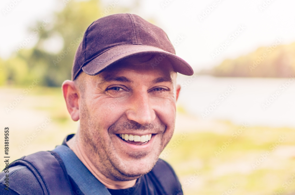Portrait of an unshaven man in a cap