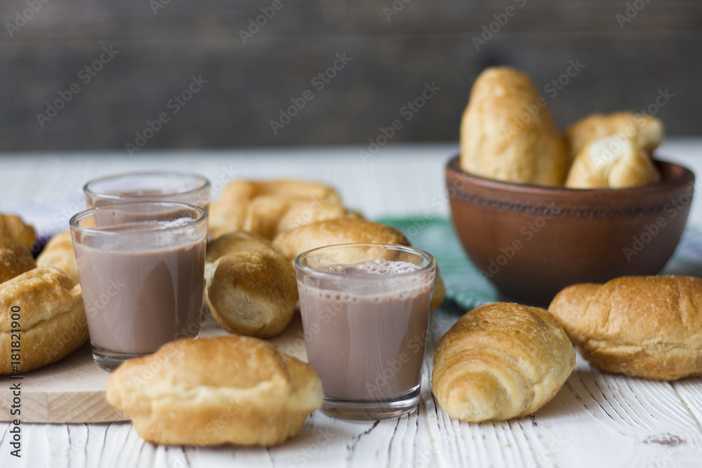 croissants and chocolate on white wooden table croissants and chocolate on white wooden table