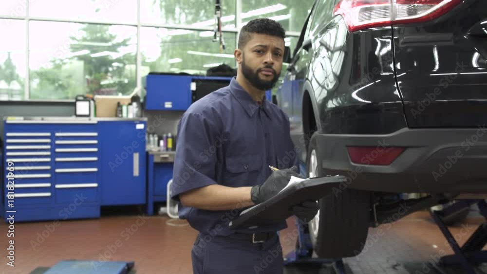 Medium shot of a mechanic taking notes Medium shot of a mechanic taking notes