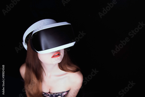 Young woman in a helmet of virtual reality. VR-headset.