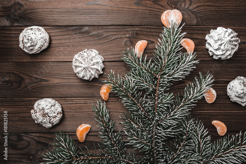 Brown wood background. Slice of mandarins. Sweets. Fir tree and cones. Christmas greeting card and new year. Xmas and Happy New Year composition. Flat lay, top view