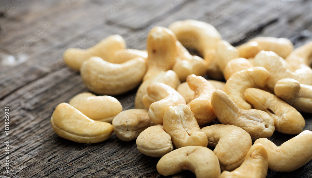 Cashews on an old wooden table, copy space Cashews on an old wooden table, copy space