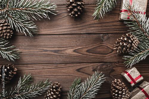 Wallpaper Mural Brown wood background. Fir branches, decorative cones. Space for the message. Gifts for xmas. Christmas greeting card and new year. Xmas and Happy New Year composition. Flat lay, top view Torontodigital.ca