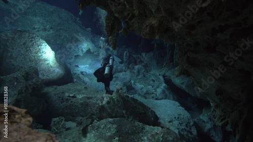 group of divers with flashlight cenote cave dos ojos
