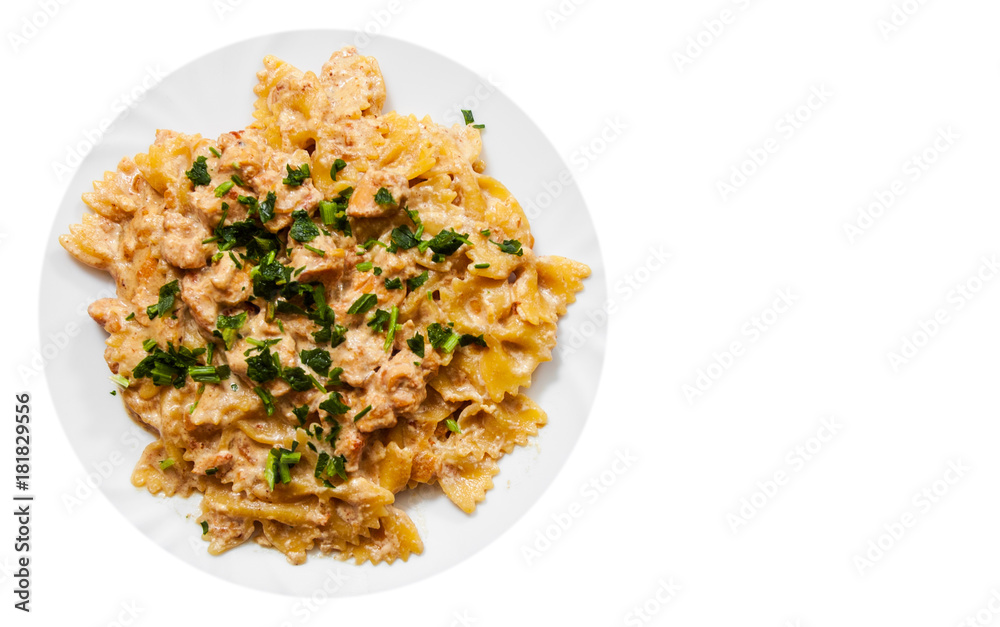 Sliced fried chicken fillet in a creamy sauce. with farfalle pasta. in plate with copy space. top view. isolated on white Sliced fried chicken fillet in a creamy sauce. with farfalle pasta. in plate with copy space. top view. isolated on white