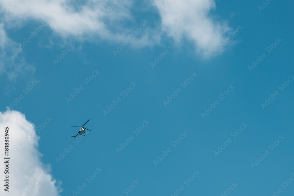 Flying small helicopter high in a blue cloudy sky. Flying small helicopter high in a blue cloudy sky.
