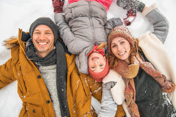 winter family lying in snow