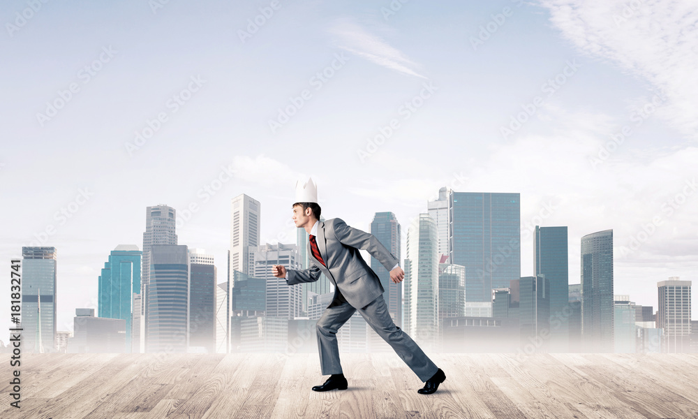 King businessman in elegant suit running and modern cityscape at King businessman in elegant suit running and modern cityscape at