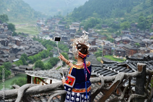 Peolple from different tribes in China dressed in traditional costumes, the miao tribe, dong tribe, gejia people, cormorant fishermen photo