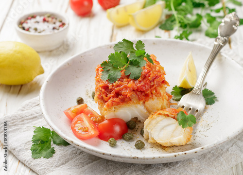White fish (cod, Pollock, nototenia, hake), braised with onions, carrots and tomatoes. Vegetable marinade. Delicious hot or cold snacks for foodies. Selective focus photo