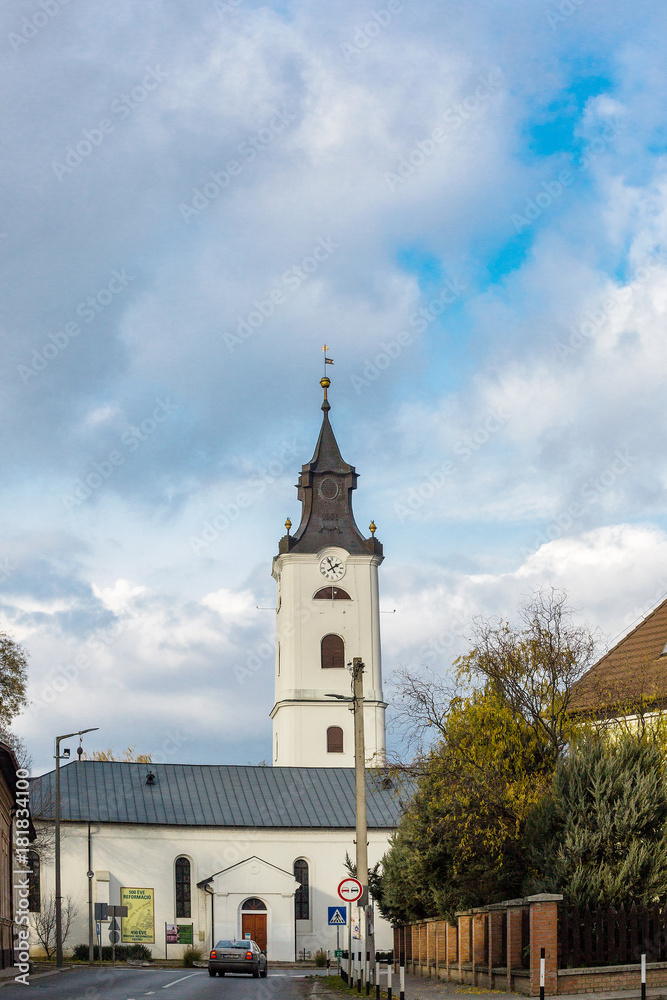 View of the reformed church against the blue sky in Nagykallo, Hungary
