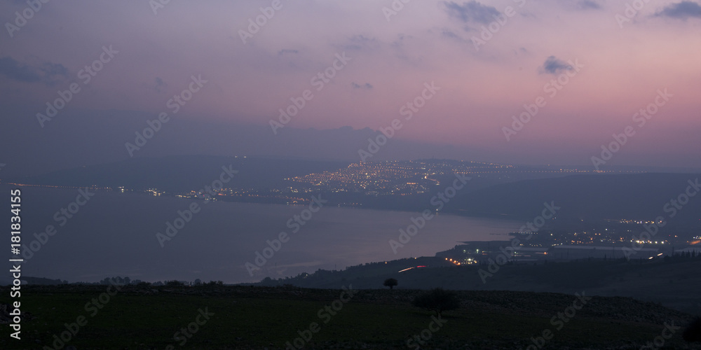 City at coast lit up at dusk, Vered HaGalil, Sea of Galilee, Galilee, Israel City at coast lit up at dusk, Vered HaGalil, Sea of Galilee, Galilee, Israel