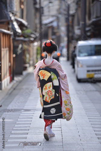 traditional japanese costumes kimono worn by a maiko with all the make up and tattos walking in the streets of gion corner kyoto japan