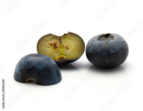 Bog blueberries isolated on white background two halves and one whole.