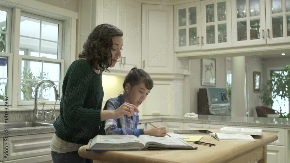 Mother helping her daughter with homework Mother helping her daughter with homework