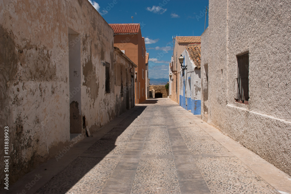 Desert street on Tabarca Island Spain with blue sky and beautiful clouds.