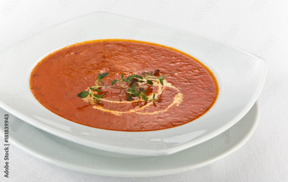 fresh tomato soup with cream in a plate
