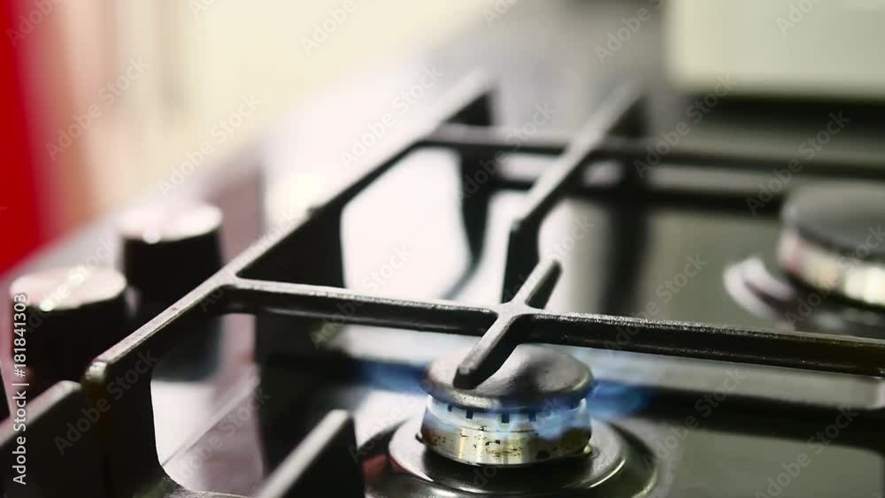 Making turkish coffee in copper cezve over gas stove. Milling of grains. On the gas stove Turk with a running coffee. Running coffee close up. gas stove with burning fire. A cup of coffee.
