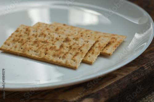 several cookies cracker on a white plate on a wooden background